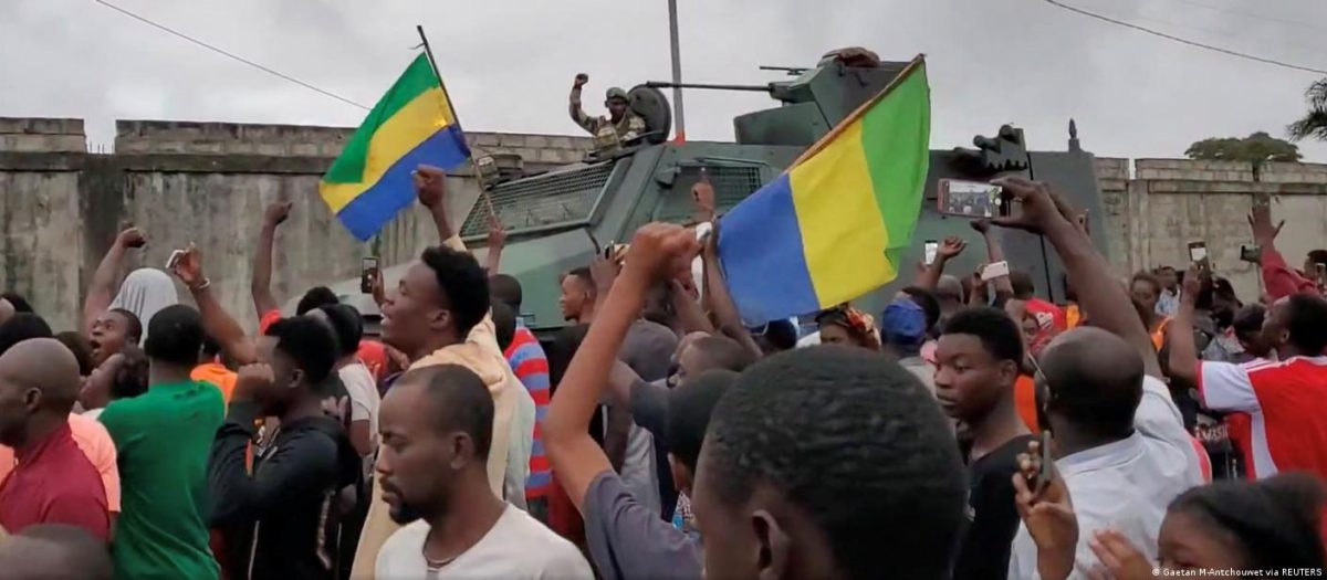 A military vehicle passes by people celebrating after military officers announced they had taken power, after the state election body announced President Ali Bongo had won a third term, in Port Gentil, Gabon August 30, 2023 in this still image obtained from social media video. 